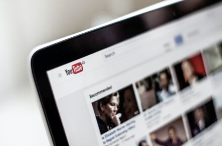 Close shot of a computer screen with YouTube's front page open